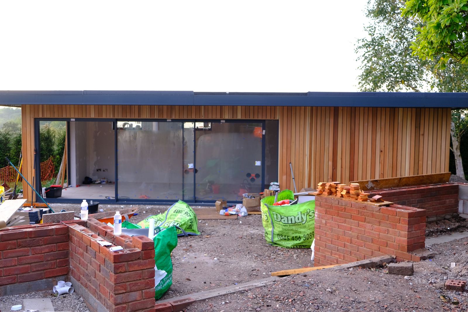 Cedar cladding and glazing being fitted to the building