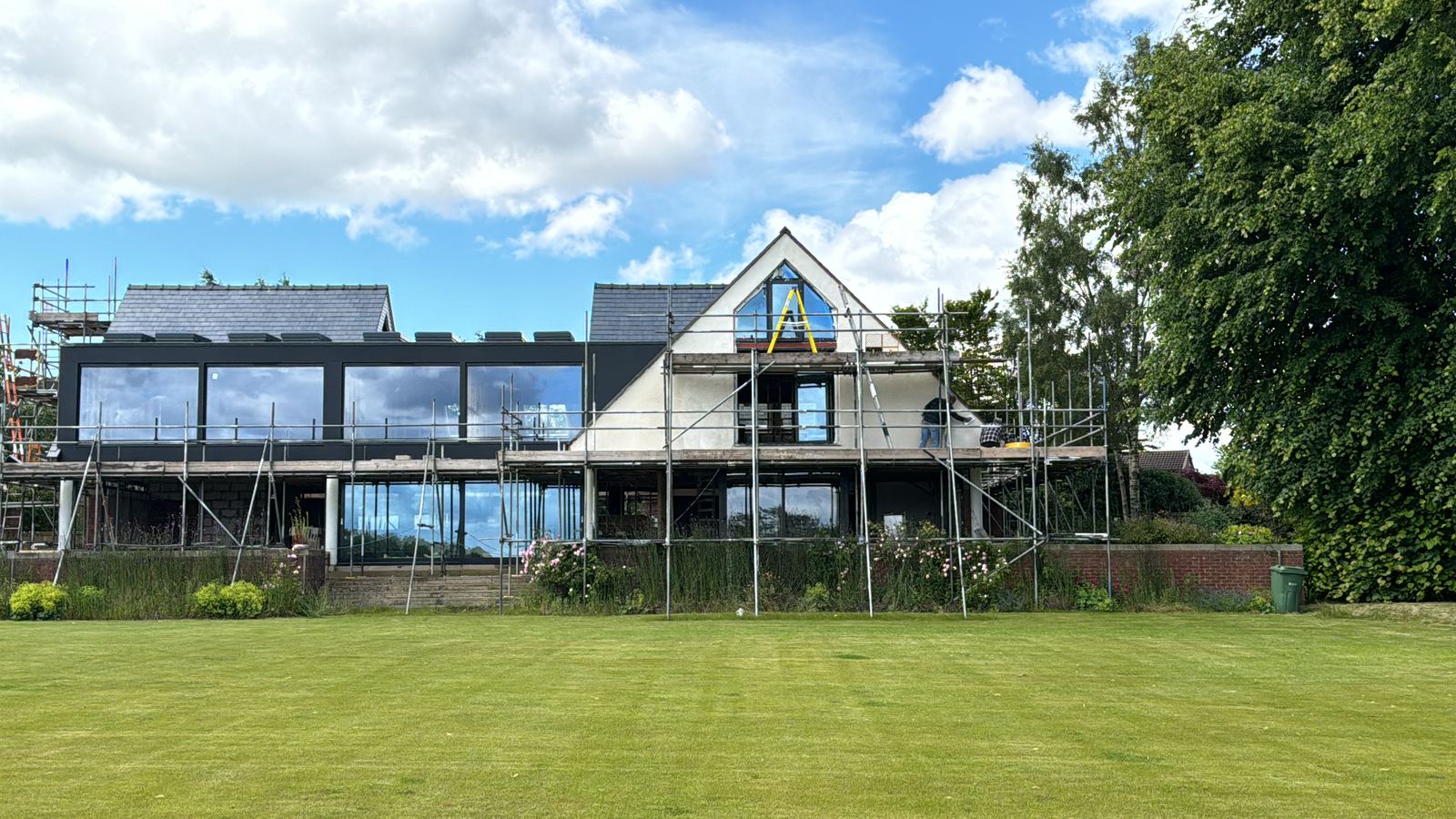 New glazing installed across the rear elevation with scaffold still standing