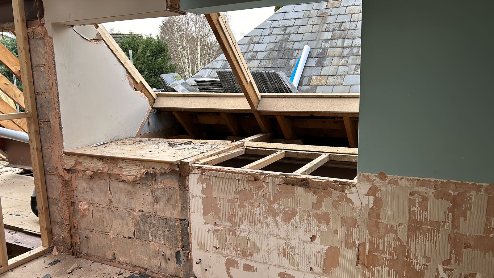 Wall and roof junction opened up showing existing timbers and blockwork
