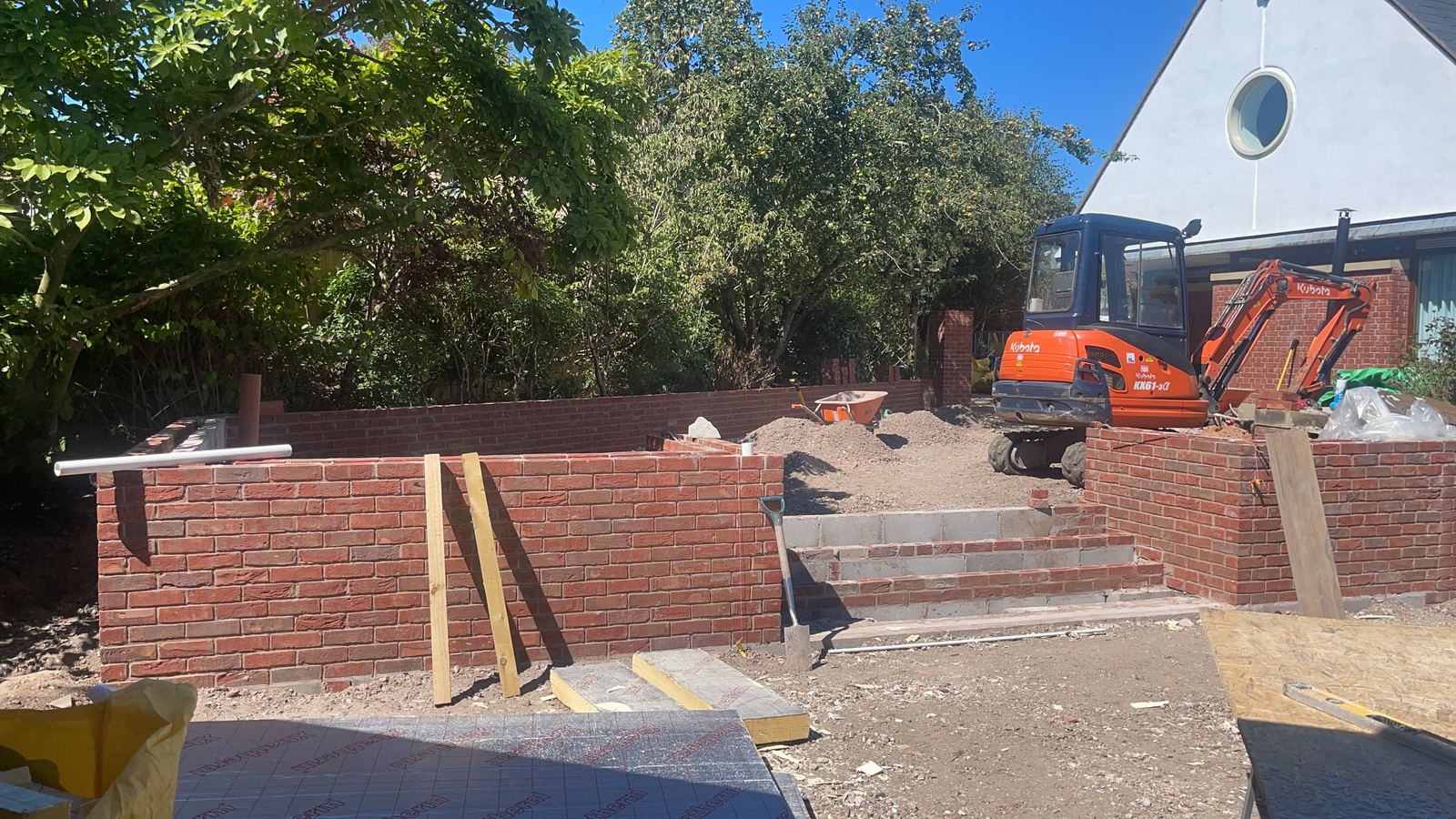 Brick retaining walls and steps forming a terraced courtyard
