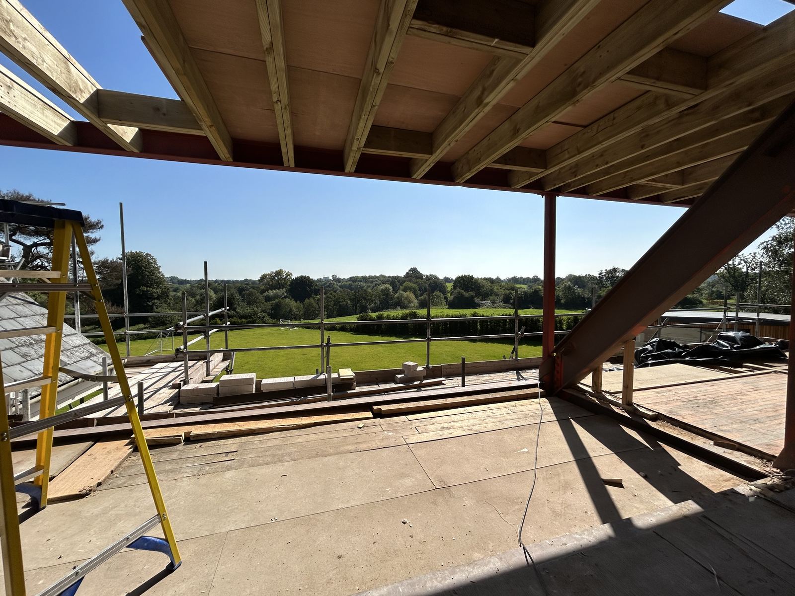 Interior with the roof opened up, looking out across open countryside