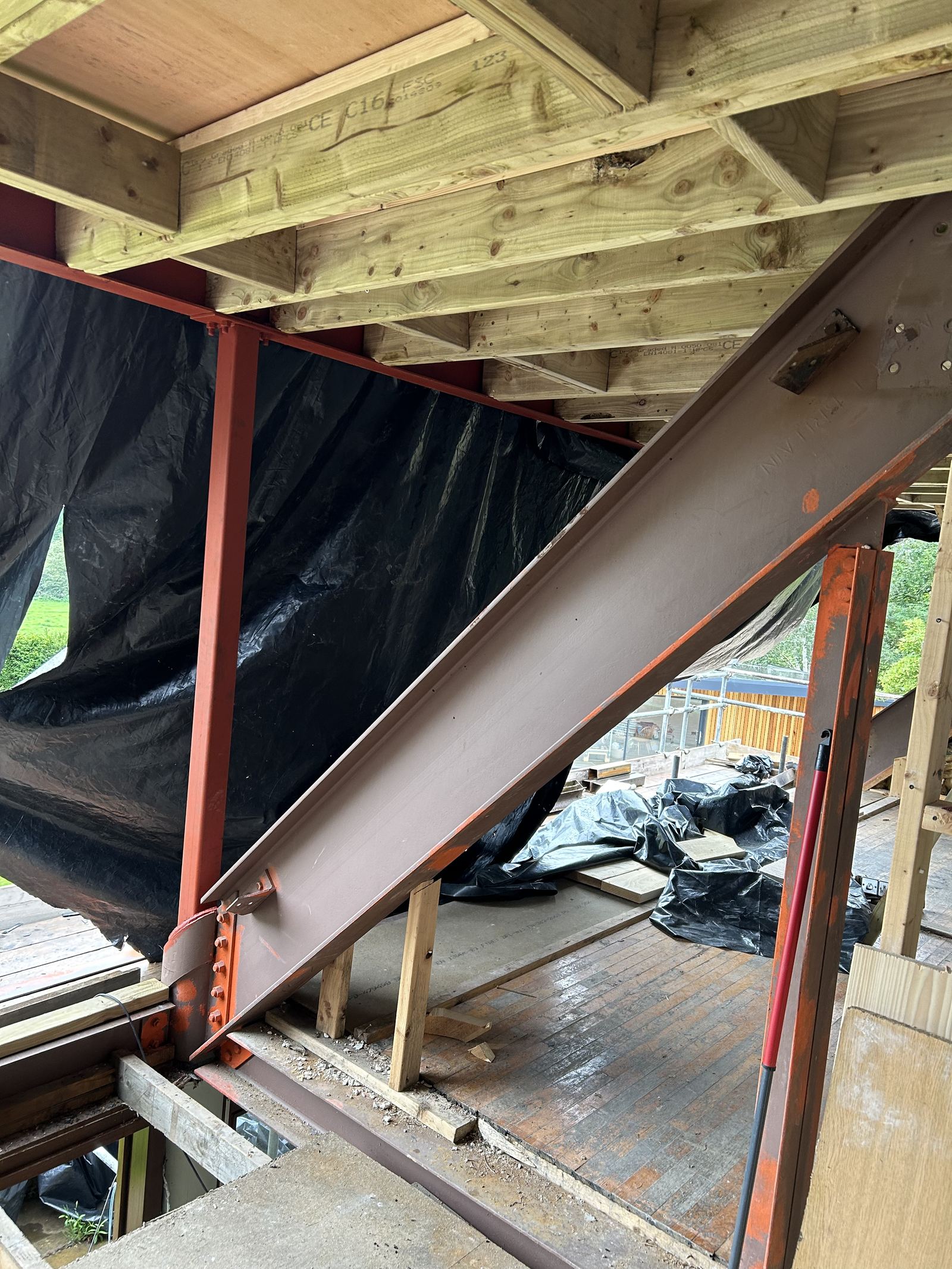 Steel beam carrying the new roof structure, with membrane behind