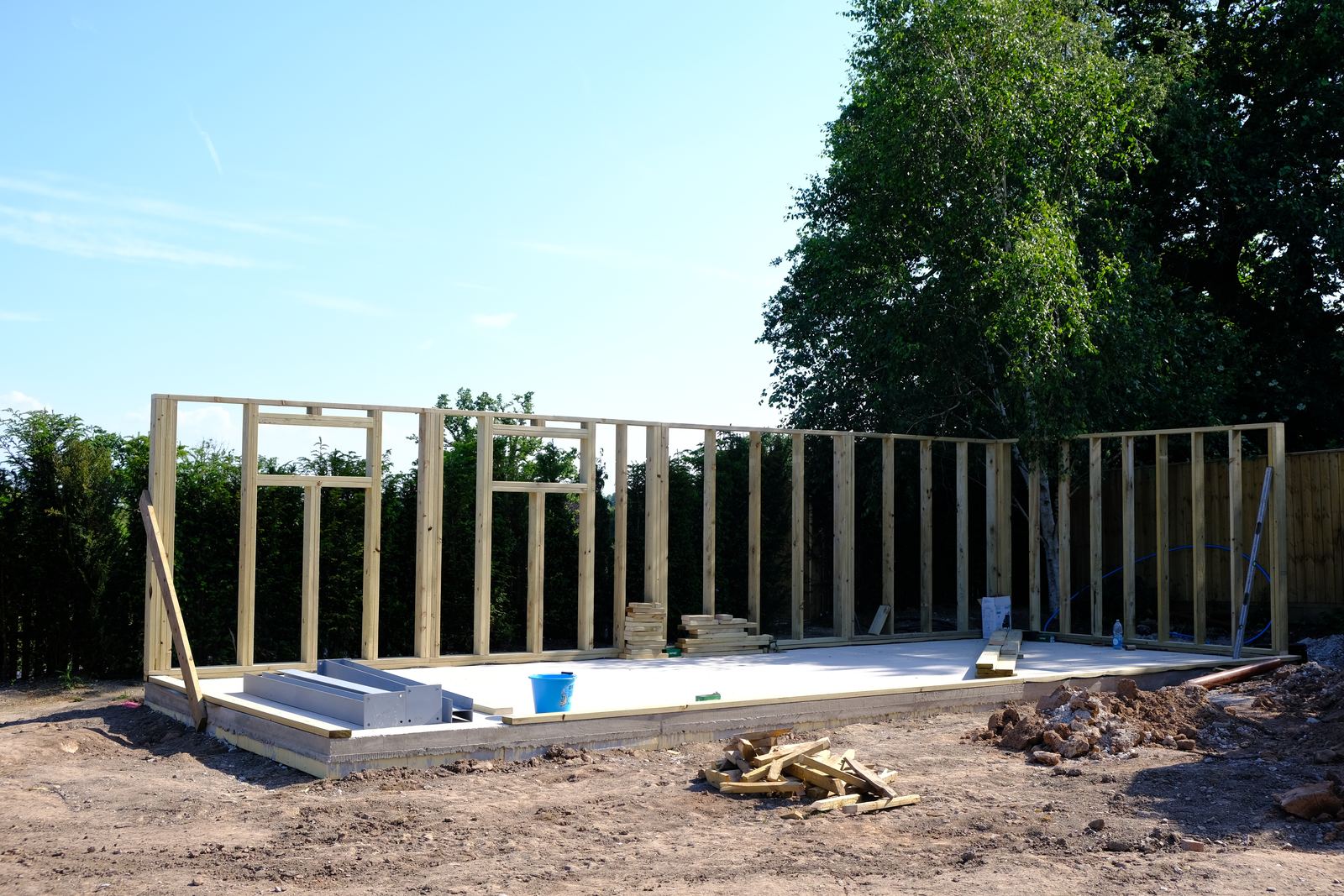 Timber frame walls standing on a new insulated slab
